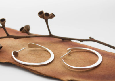 Hoop forged silver earrings, intricate flat shape. Light and comfortable. Modern chic style for an urban look. Everyday jewelry